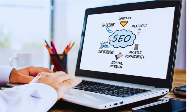 A professional working on a laptop displaying a diagram about Professional SEO Services in Kendall, highlighting elements like content, backlinks, link building, mobile compatibility, headings, and social media.