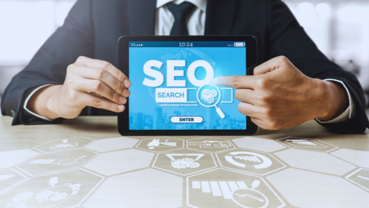 A business professional holding a tablet displaying the word “SEO” with search-related icons, symbolizing digital marketing and optimization services offered by an SEO Company in Kendall.